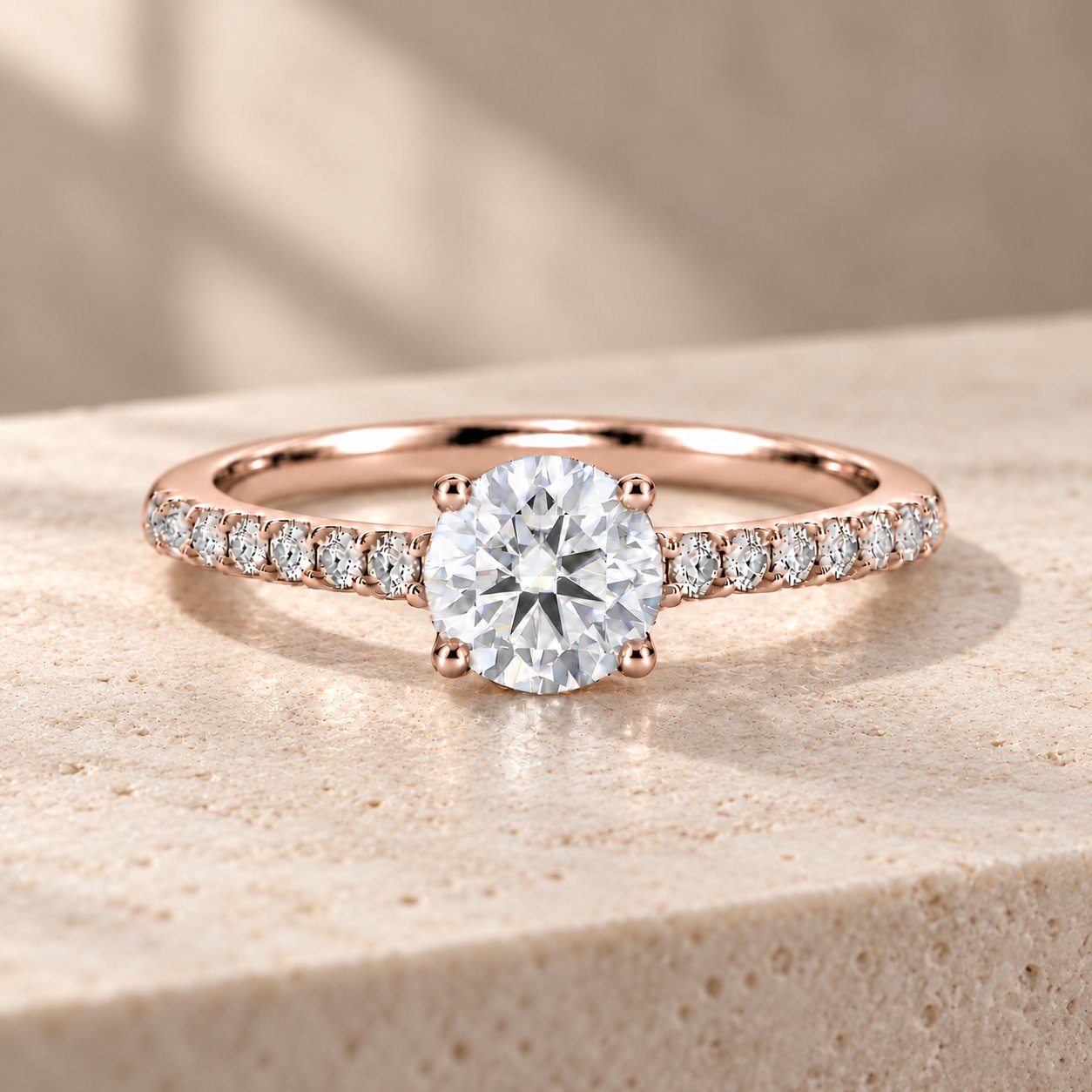 Rose-gold round moissanite engagement ring with a delicate pavé band